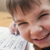 Homeschool boy writing name