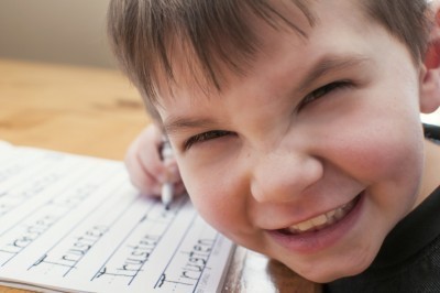 Homeschool boy writing name